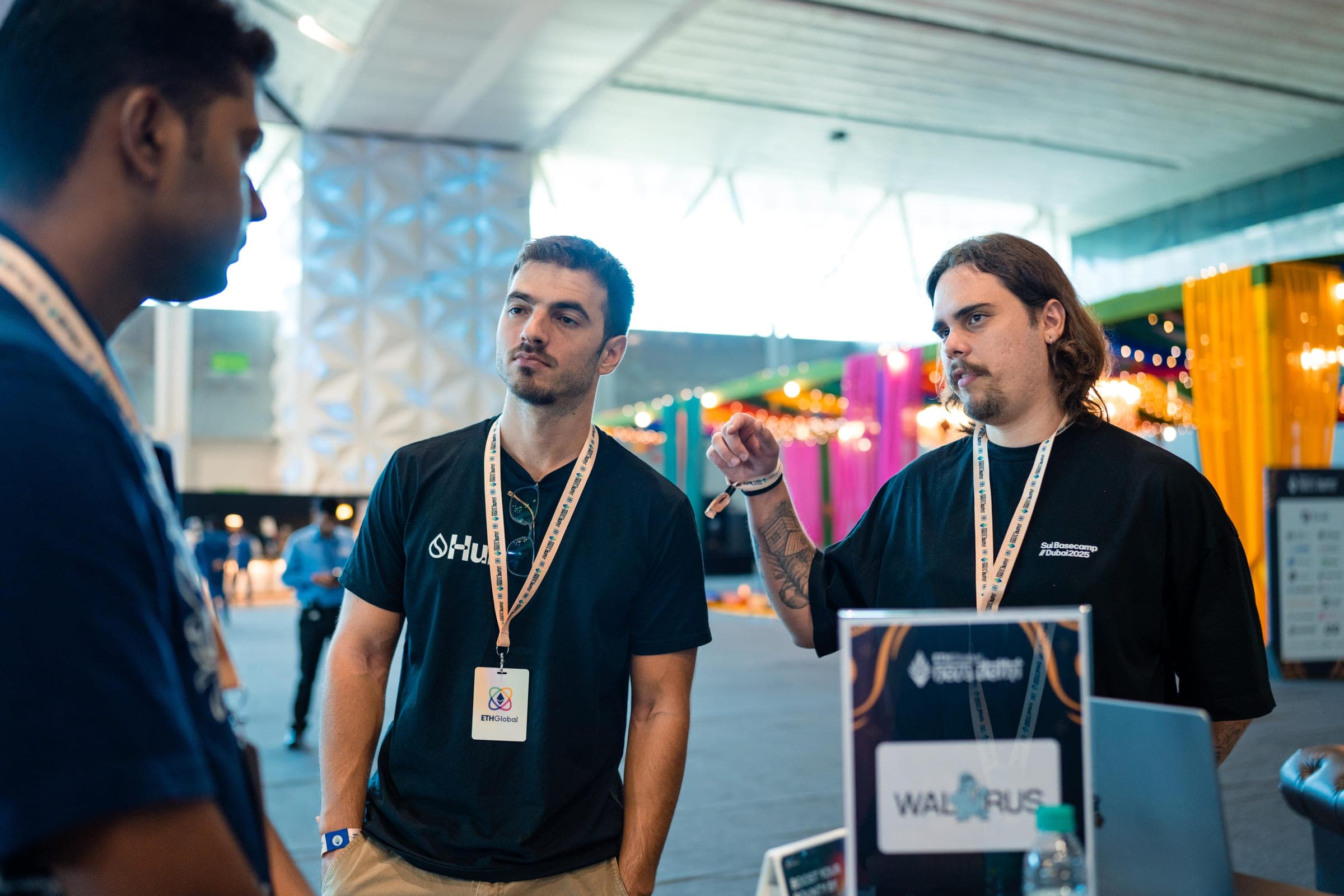 Guilherme and a colleague talk with a builder at the Walrus booth at ETHGlobal New Delhi.